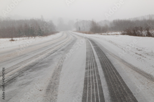 Car tire footprints on a snowy road. Soft focus and selective focus