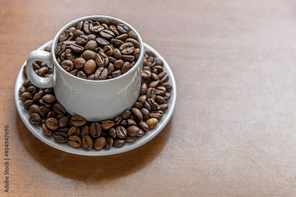 Fototapeta premium coffee beans in white porcelain cup and saucer