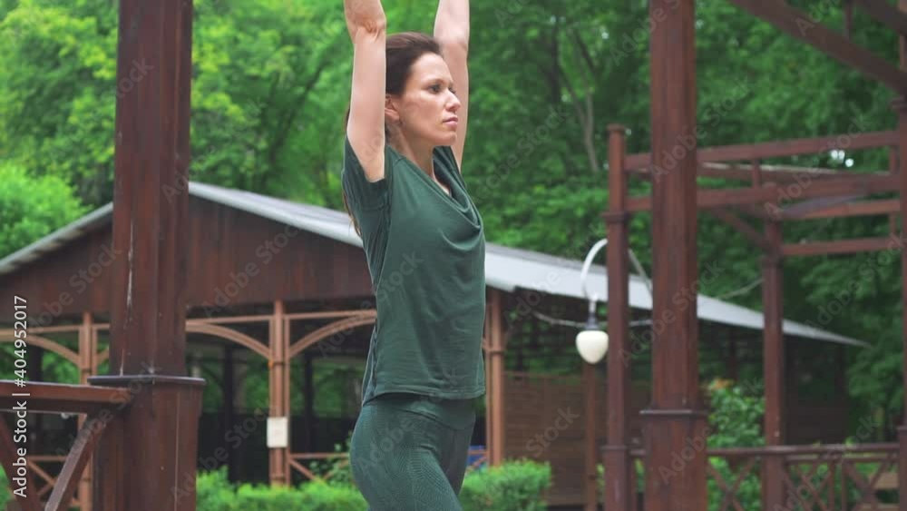 Young woman doing yoga exercises in the park. Concept of healthy lifestyle and relaxation Young woman doing yoga exercises in the park. Concept of healthy lifestyle and relaxation