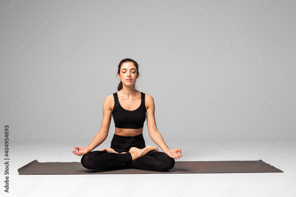 young woman practicing yoga in the lotus position, isolated on white background young woman practicing yoga in the lotus position, isolated on white background