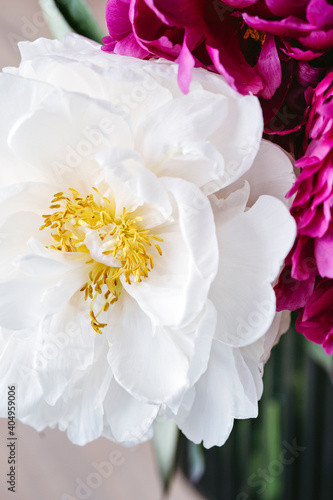 A bouquet of colorful peonies in a vase.