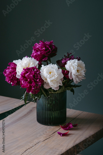 A bouquet of colorful peonies in a vase. © Irina Polonina