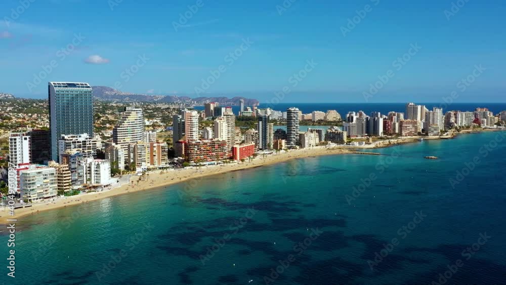 Aerial view with a drone of the beach in Calp city, Spain. Beautiful beach, perfect for tourism near the Mediterranean Sea under the sunlight 4K Aerial view with a drone of the beach in Calp city, Spain. Beautiful beach, perfect for tourism near the Mediterranean Sea under the sunlight 4K