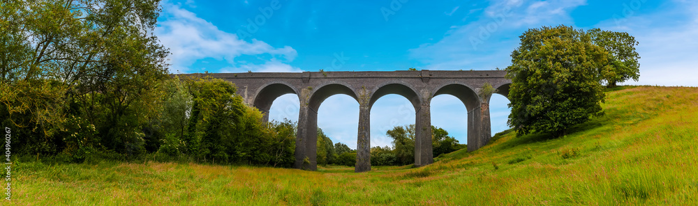 A view from the meadow of the northern side of the derelict and abandoned viaduct near Catesby, Northamptonshire, UK