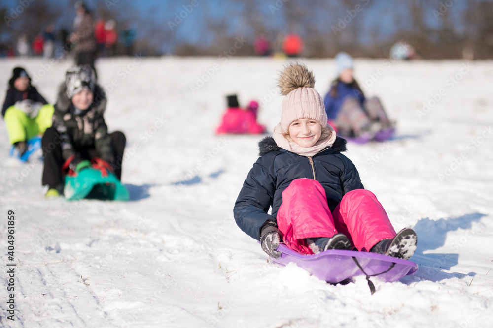 Little girl sliding with bob and falling in the snow. Little girl sliding with bob and falling in the snow.