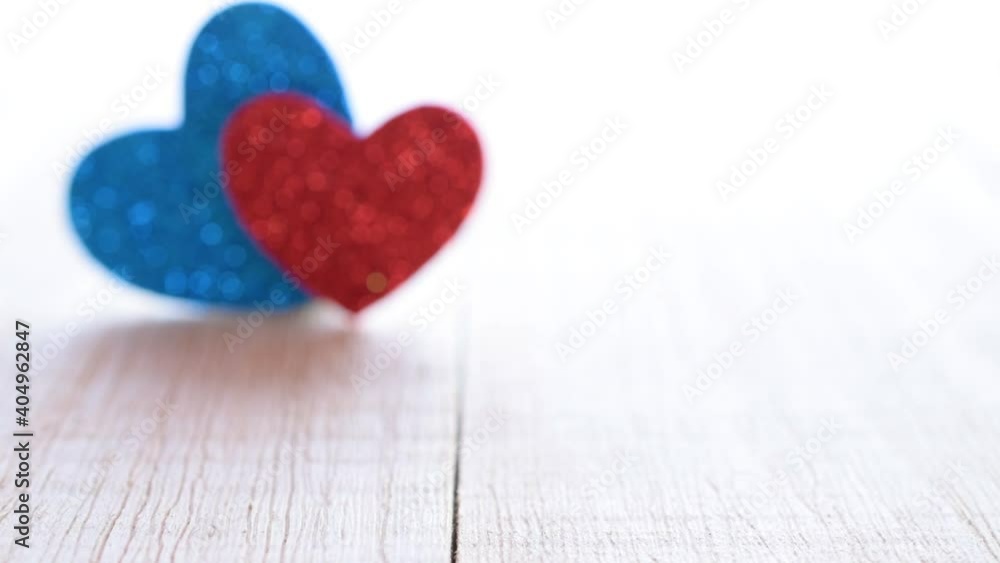 Saint Valentin blurred background: red love hearts on wooden table. Romantic message template with copy space in soft focus Saint Valentin blurred background: red love hearts on wooden table. Romantic message template with copy space in soft focus