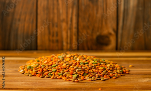 Lentils on a dark wooden board  with a wooden background