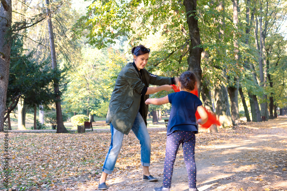Playful mother and daughter having fun in the park. Playful mother and daughter having fun in the park.