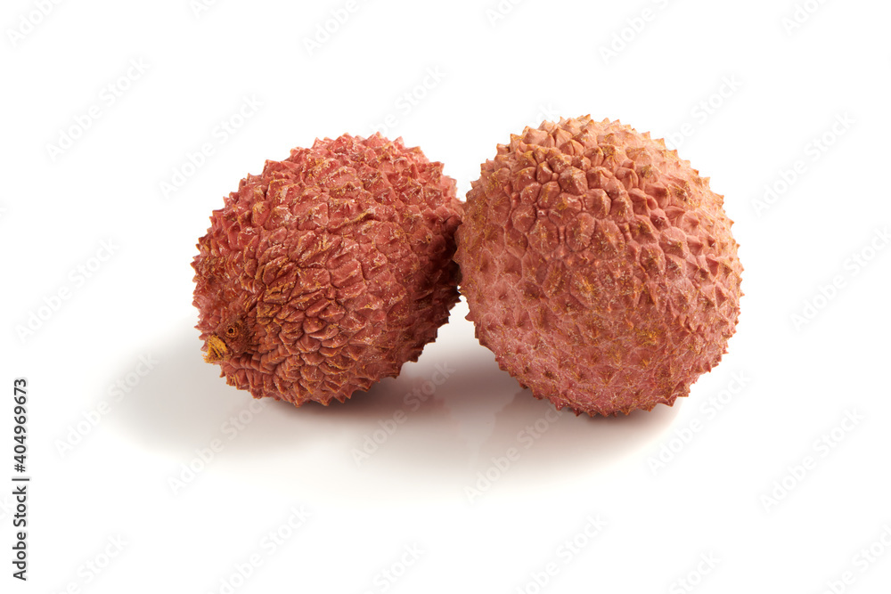 Two sweet ripe lychee fruits isolated on white background. Close up view. Two sweet ripe lychee fruits isolated on white background. Close up view.