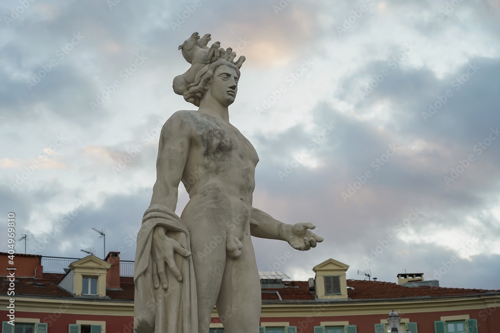 The statue of Apollo at Place Massena in Nice. Beautiful evening sky at sunset.