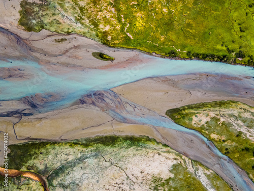 Delta of glacial river with sandy shore aerial view