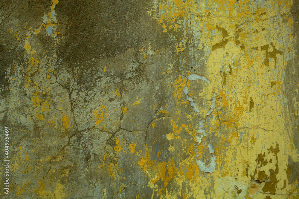 Background texture of cracked concrete wall with remnants of old green paint in a full frame view. This is a lighter version, a darker version is also available in the portfolio