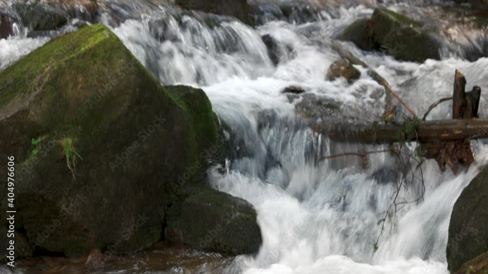 River stream running among the rocks in mountain. Forest stream between stones close up. River stream running among the rocks in mountain. Forest stream between stones close up.
