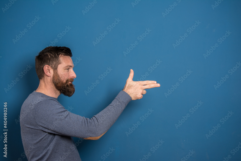 Portrait of a young man in a studio on a blue background. Portrait of a young man in a studio on a blue background.