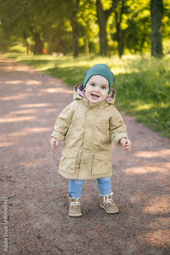One year old baby on the path in the park