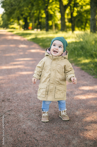 One year old baby on the path in the park