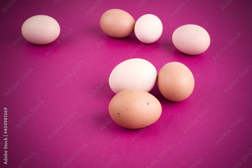 Chicken eggs on a pink background. Place for your text. Close-up Chicken eggs on a pink background. Place for your text. Close-up