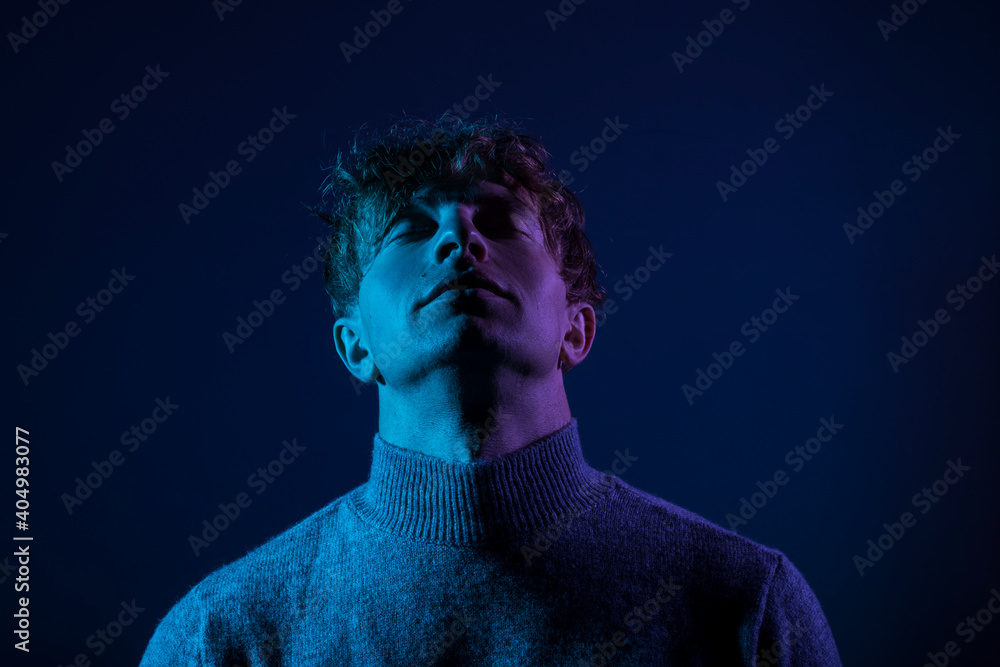 Neon light studio portrait of serious man model. Man neon. Light. Background. Face. Neon light studio portrait of serious man model. Man neon. Light. Background. Face.