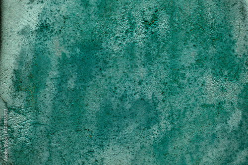 Grunge weathered and stained old painted green wall background texture in a full frame view. This is a lighter version, a darker version is also available in the portfolio