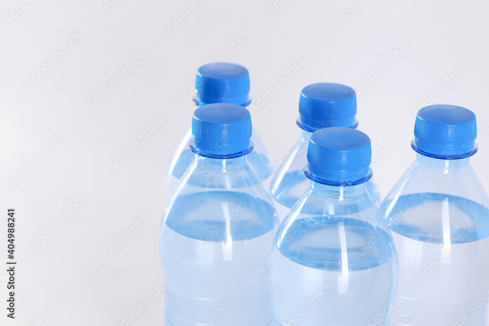 Plastic bottles with pure water on white background, closeup Plastic bottles with pure water on white background, closeup