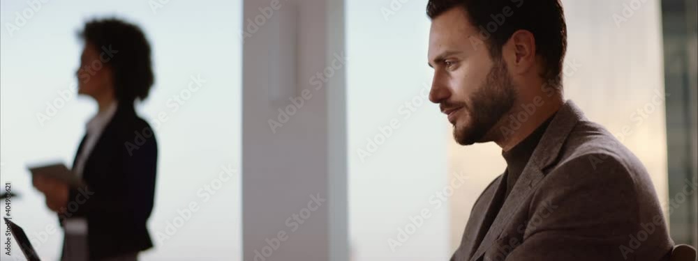 Adult man sitting in his office and having video conference call. Smiling bearded Caucasian businessman. Adult man sitting in his office and having video conference call. Smiling bearded Caucasian businessman.