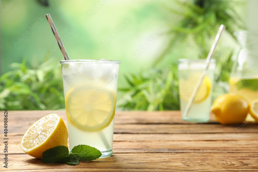 Fototapeta premium Natural lemonade with mint and fresh fruit on wooden table, space for text. Summer refreshing drink