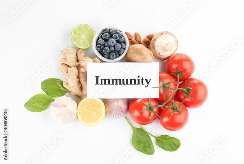Set of natural products and card with word Immunity on white background, top view