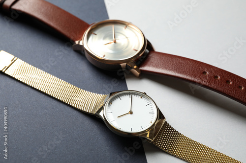 Luxury wrist watches on color background, closeup