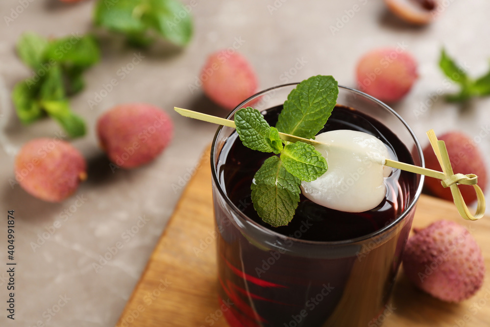 Lychee cocktail with mint and fresh fruits on grey table, closeup Lychee cocktail with mint and fresh fruits on grey table, closeup