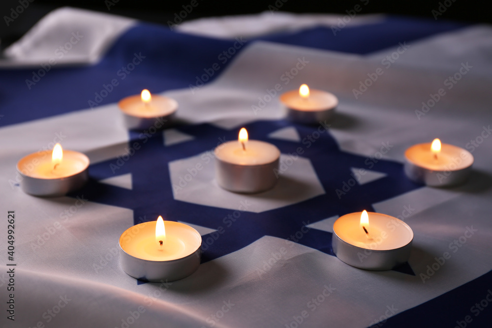 Burning candles on flag of Israel. Holocaust memory day Burning candles on flag of Israel. Holocaust memory day
