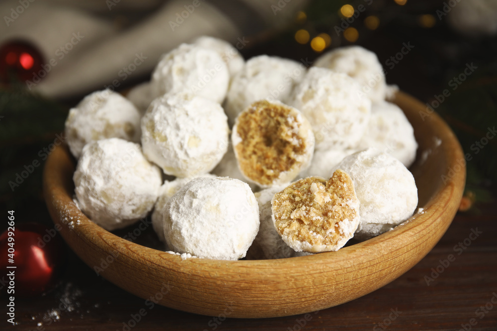 Tasty snowball cookies in wooden bowl on table, closeup. Christmas treat Tasty snowball cookies in wooden bowl on table, closeup. Christmas treat