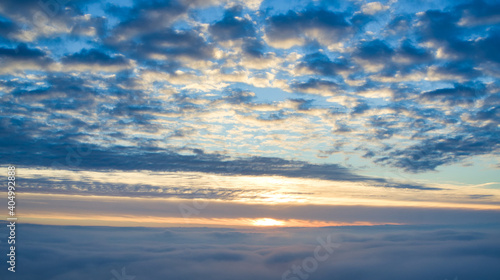 Aerial View of Sunrise over Clouds