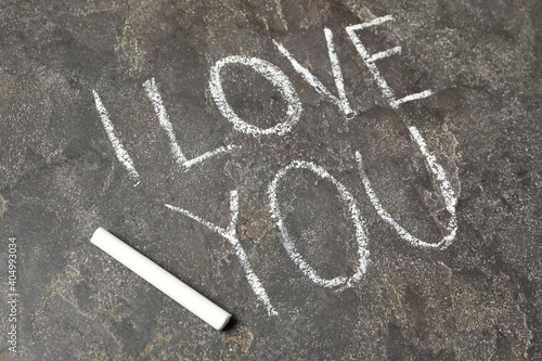 Text I Love You and chalk piece on grey stone background