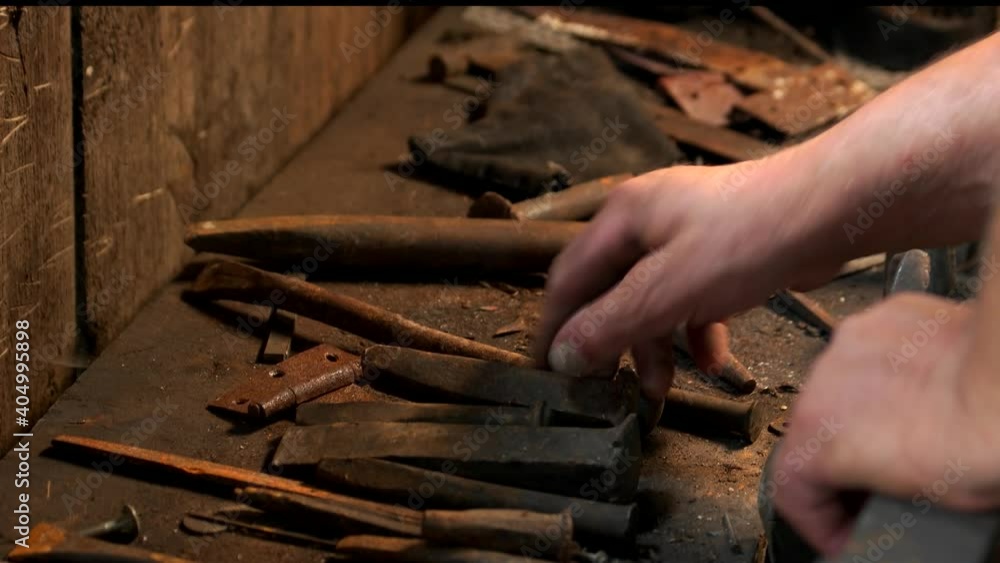 Working metal tools in blacksmiths workshop. Blacksmith at the workshop. Manufacturing of metal products. Working metal tools in blacksmiths workshop. Blacksmith at the workshop. Manufacturing of metal products.