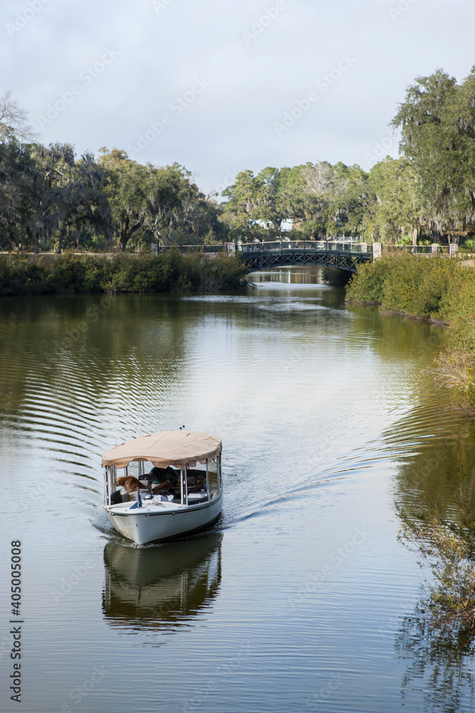 A small boat plies the canal in Palmetto Bluff, an exclusive community in South Carolina