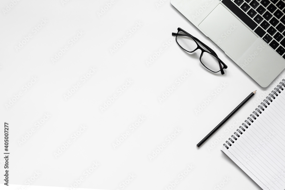 White office desk. table with blank notebook, tablet, calculator, computer and other office supplies. Top view with copy space. White office desk. table with blank notebook, tablet, calculator, computer and other office supplies. Top view with copy space.