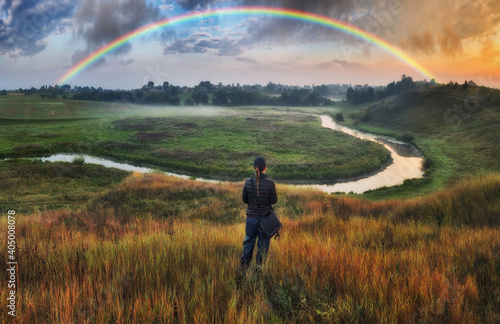 Woman Looking At Rainbow. rainbow over the autumn river