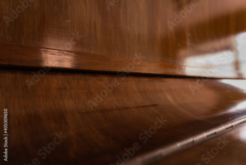 Closed piano brown wood texture close up