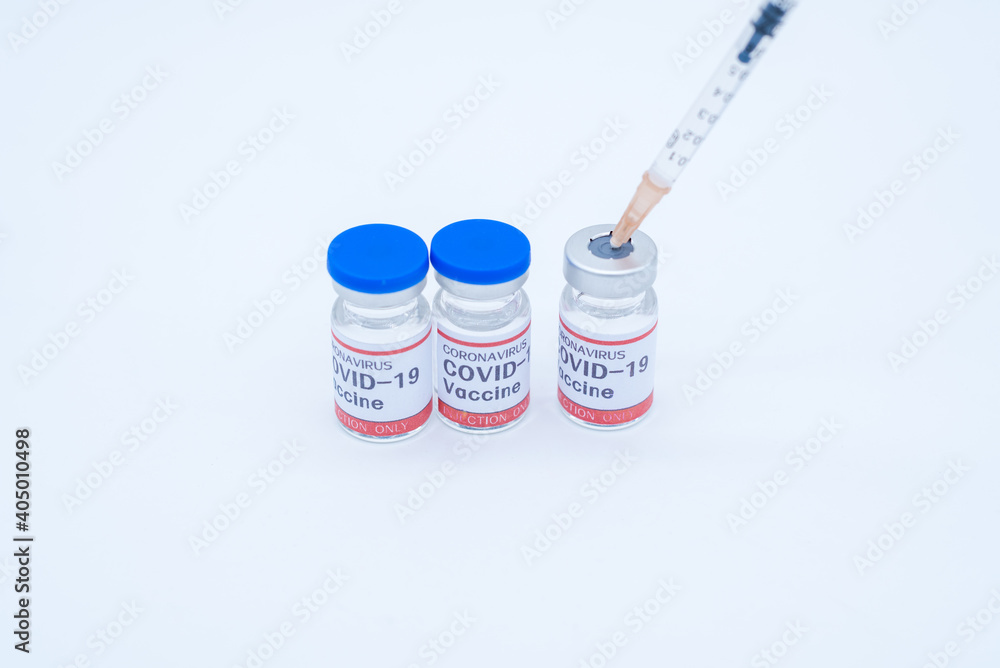 two medical syringes and three bottles of COVID-19 vaccines two medical syringes and three bottles of COVID-19 vaccines