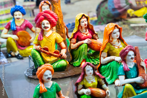 Colorful male and female Terracotta dolls dressed in traditional Indian dresses, playing musical instruments, made in Krishnanagar, Nadia, West Bengal, for sale in Handicraft Fair in Kolkata.