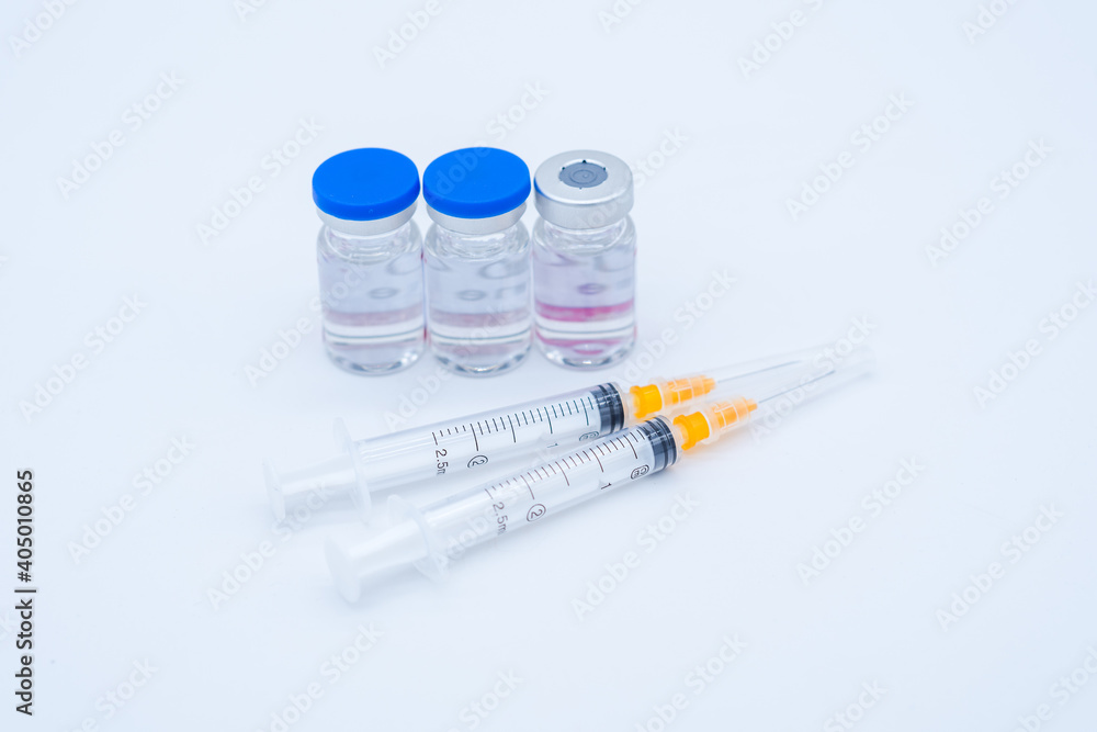 two medical syringe and three bottles of medicine two medical syringe and three bottles of medicine
