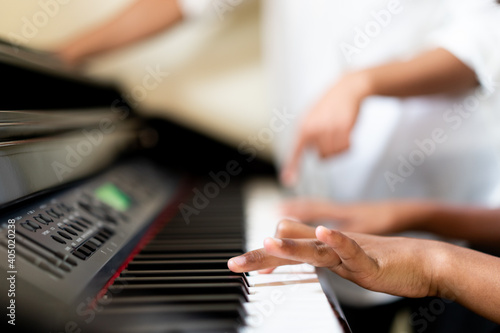 Canvas Print Pre teens girl 12 years old play piano sing a song and worship in sunday service live streaming video at home