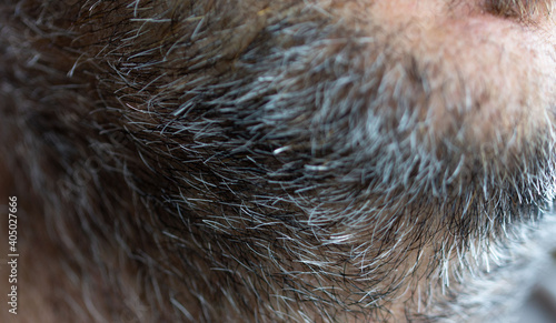 Close-up of an unshaven male face. Selective close-up macro photography with a blurry background