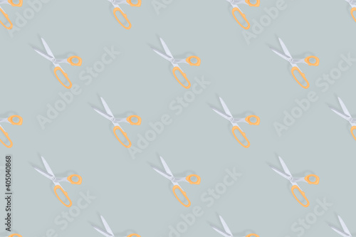 Scissors seamless pattern. Barber scissors against gray background backdrop. © Zuev Ali