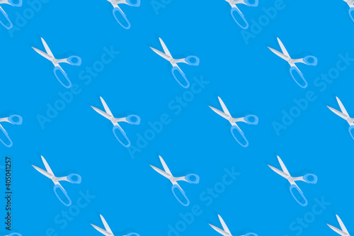 Scissors seamless pattern. Barber scissors against blue background backdrop.
