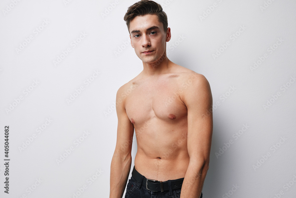 Fototapeta premium Sexy couple with a naked torso looks forward on a light background