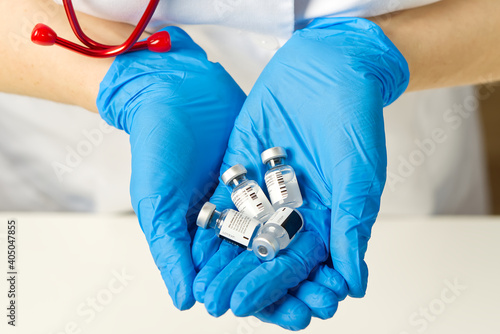 doctor holds in hands small ampoules of Covid-19 vaccine