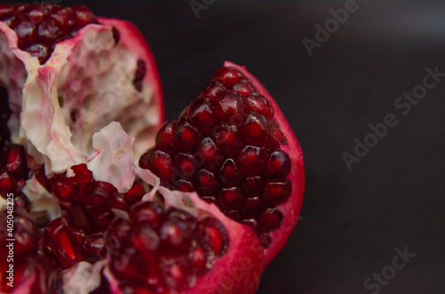 fresh pomegranate isolated on black background close-up
