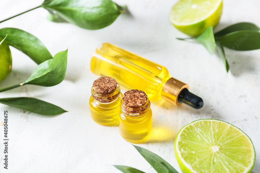 Composition with bottles of essential oil on light background Composition with bottles of essential oil on light background