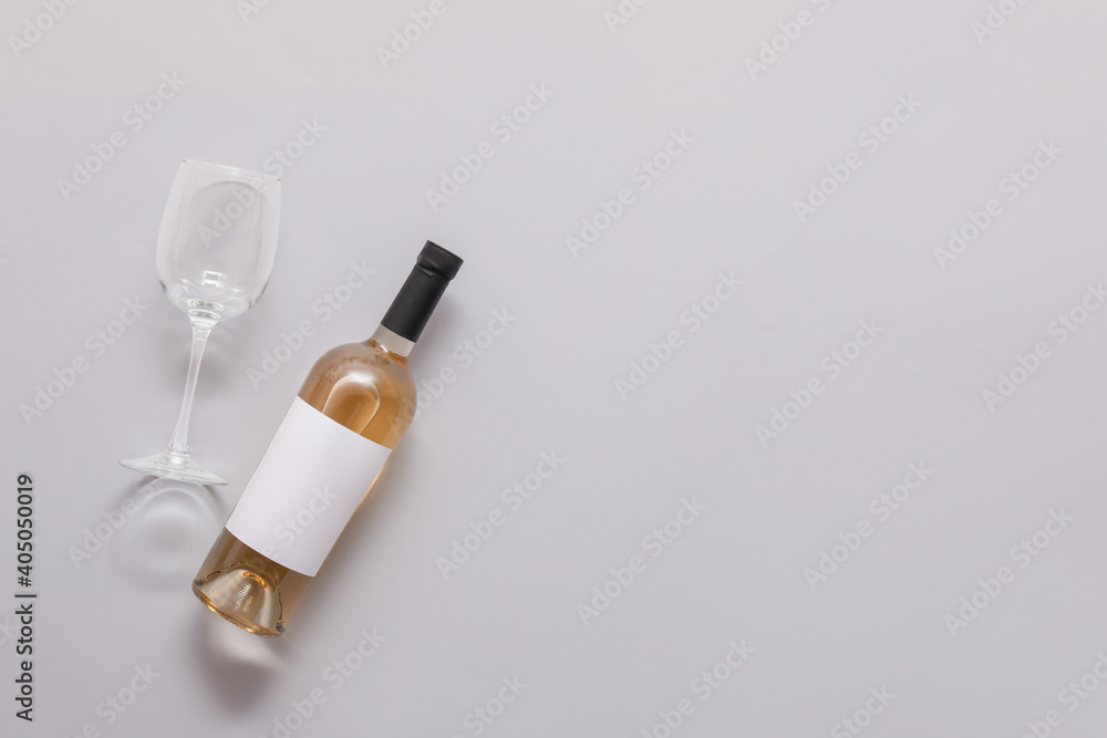 Bottle of wine with blank label and glass on light background Bottle of wine with blank label and glass on light background